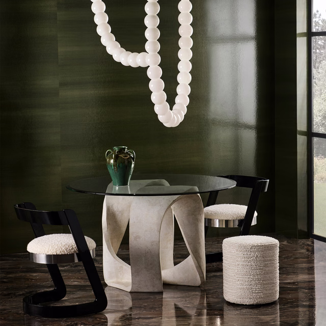 Pale ivory nubby upholstery covering dining chairs and a cylindrical stool