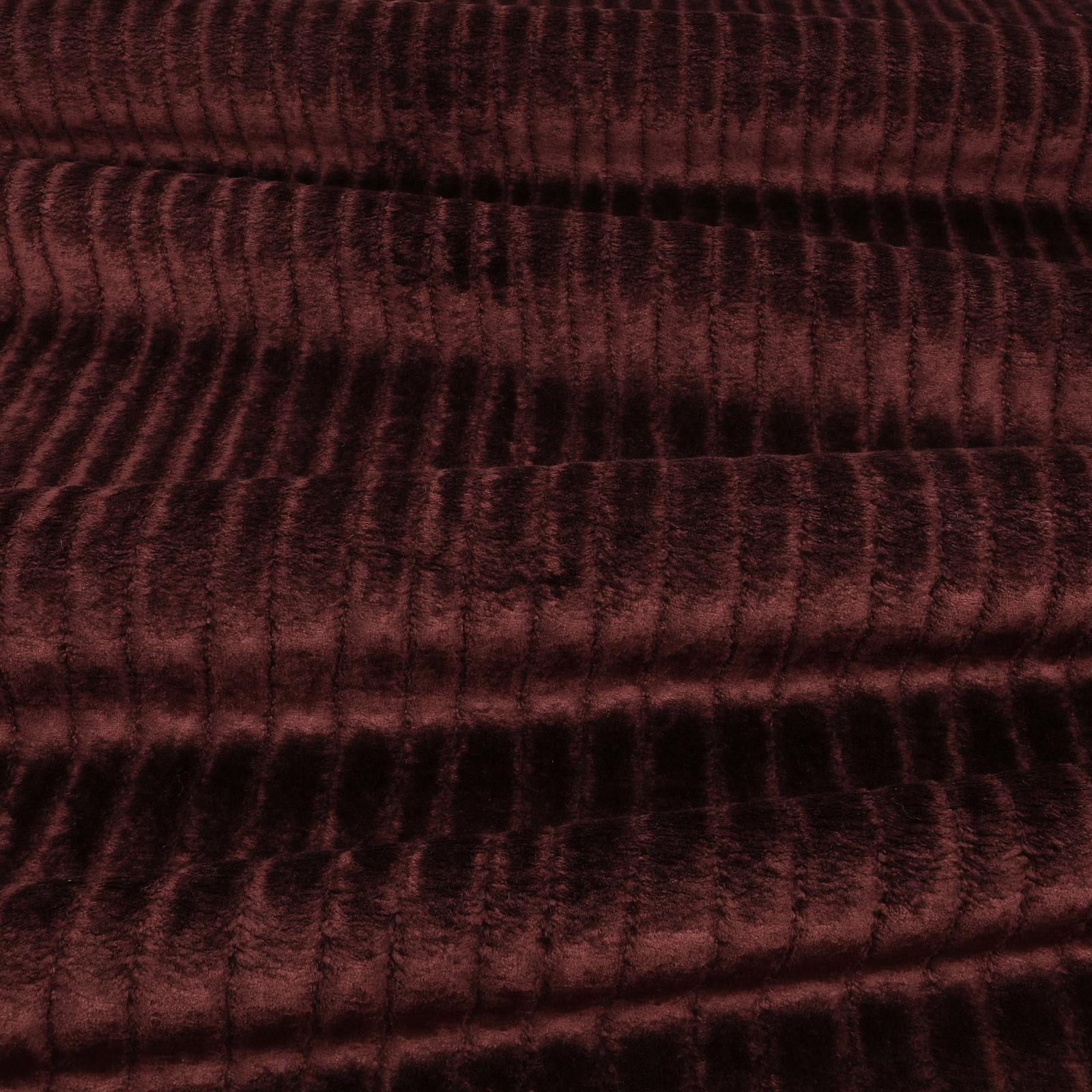 Dark burgundy velvet with rippled ridges, shifting wine-red highlights and deep black shadows