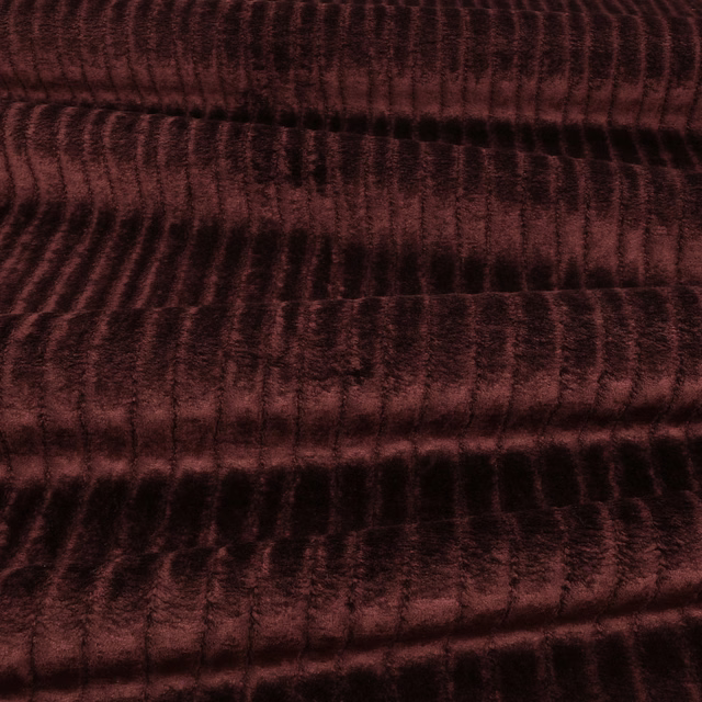 Dark burgundy velvet with rippled ridges, shifting wine-red highlights and deep black shadows