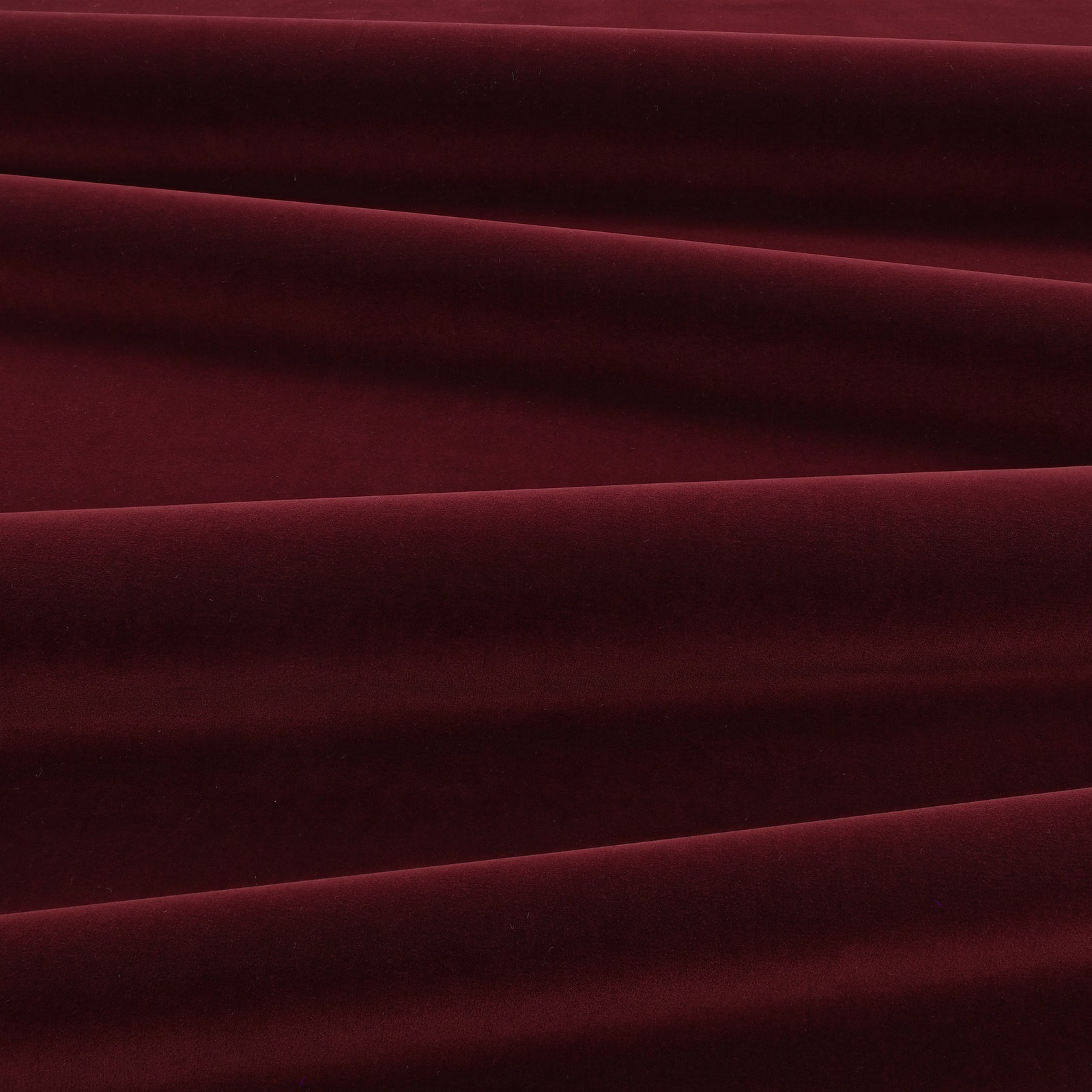 Deep eggplant velvet swatch with burgundy highlights across folded, light-catching pile