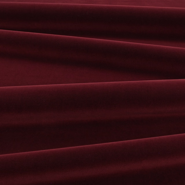 Deep eggplant velvet swatch with burgundy highlights across folded, light-catching pile