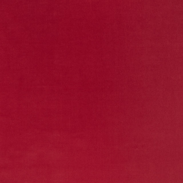 Close-up of saturated raspberry-red velvet with softly directional plush pile