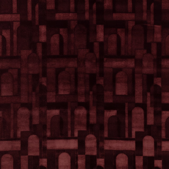 Deep burgundy textile with muted red arches and shadowed geometric blocks