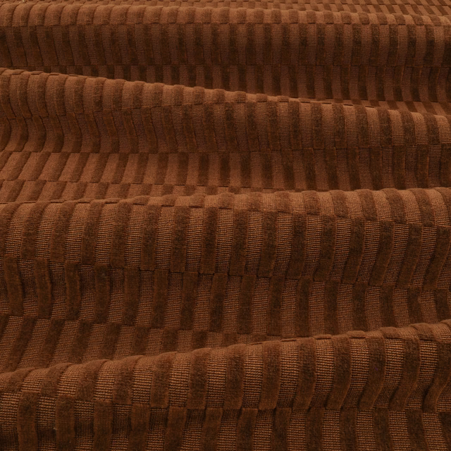 Deep chocolate-brown textile with raised vertical ribs and stepped block-like woven texture