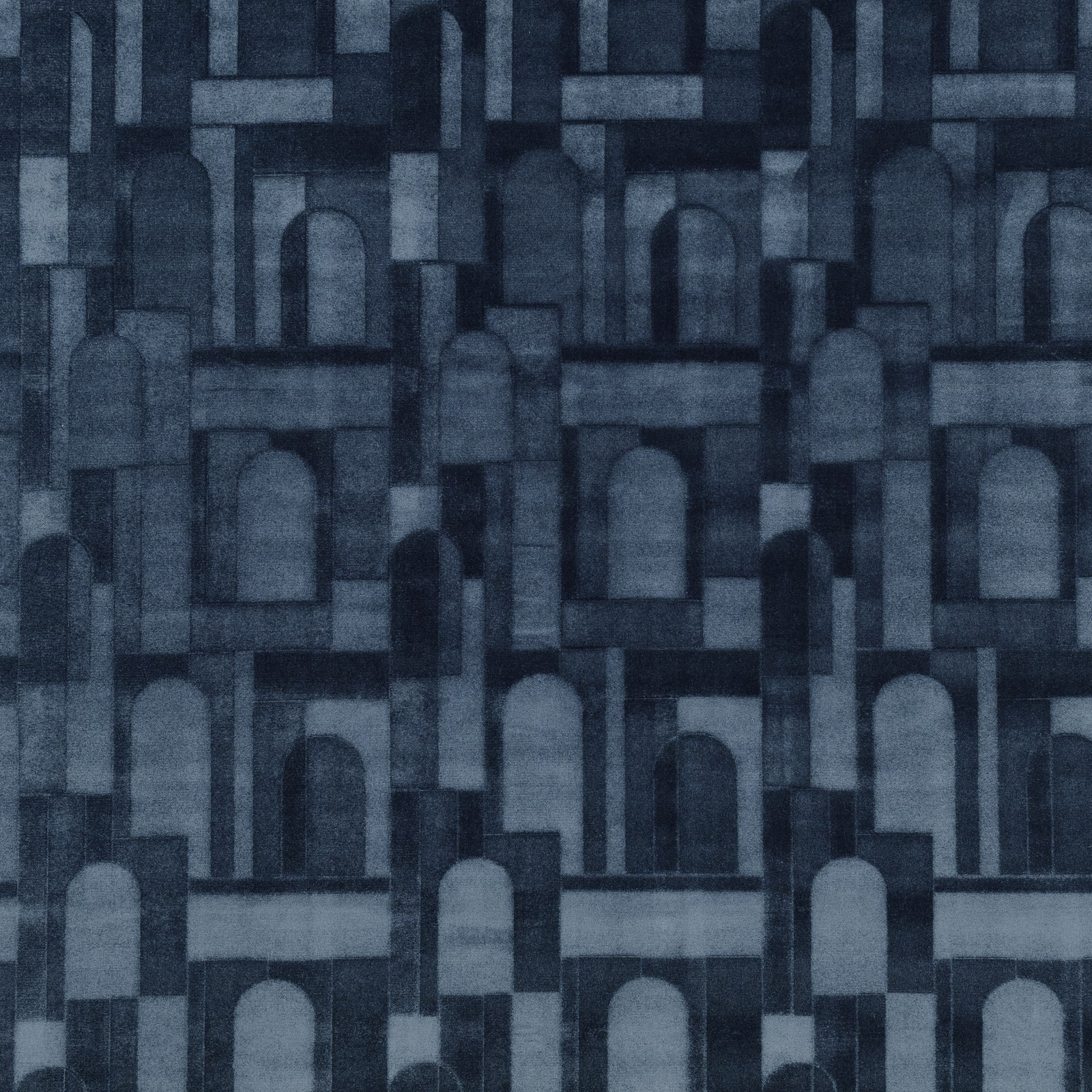 Dark twilight-blue textile with layered architectural arches and softly mottled woven texture