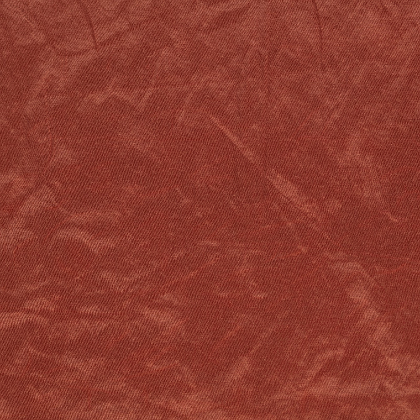 Warm brick-red fabric with mottled, softly brushed tonal texture and subtle linear marks