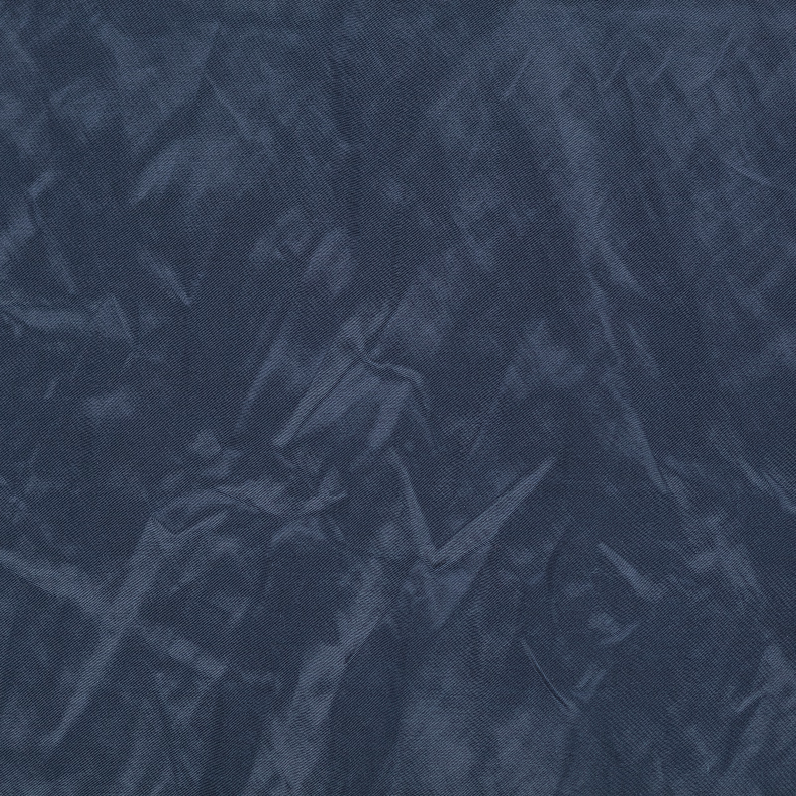 Deep indigo textile with smoky painterly striations and a soft sheen