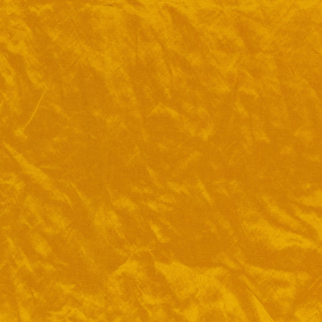 Mottled ochre textile with softly brushed golden velvet-like texture and tonal movement