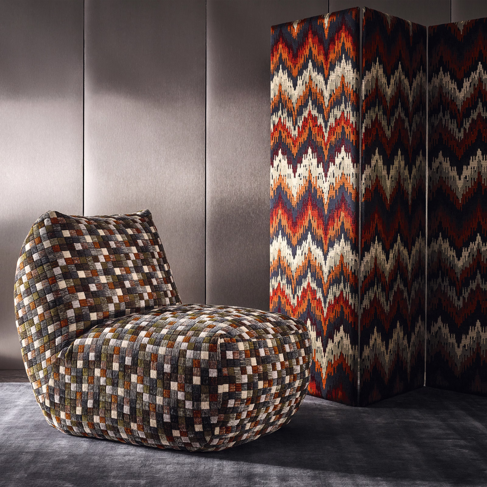 Rounded chair upholstered in rust, cream, brown and charcoal woven checks