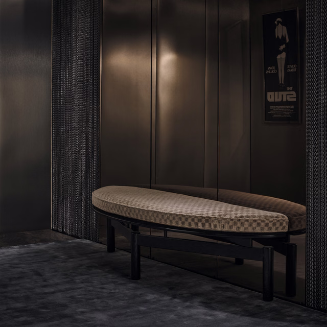 Warm mushroom-beige upholstery with a small tonal geometric woven pattern