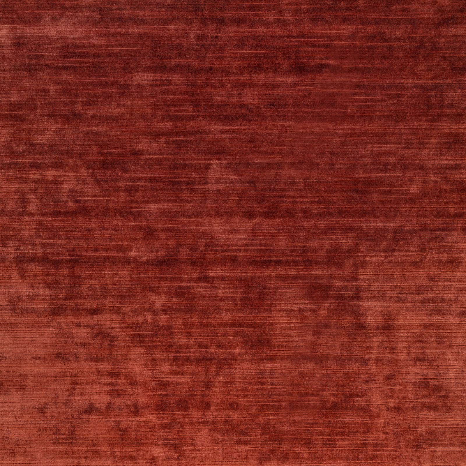 Deep rust terracotta textile with horizontal striations and softly mottled brushed texture
