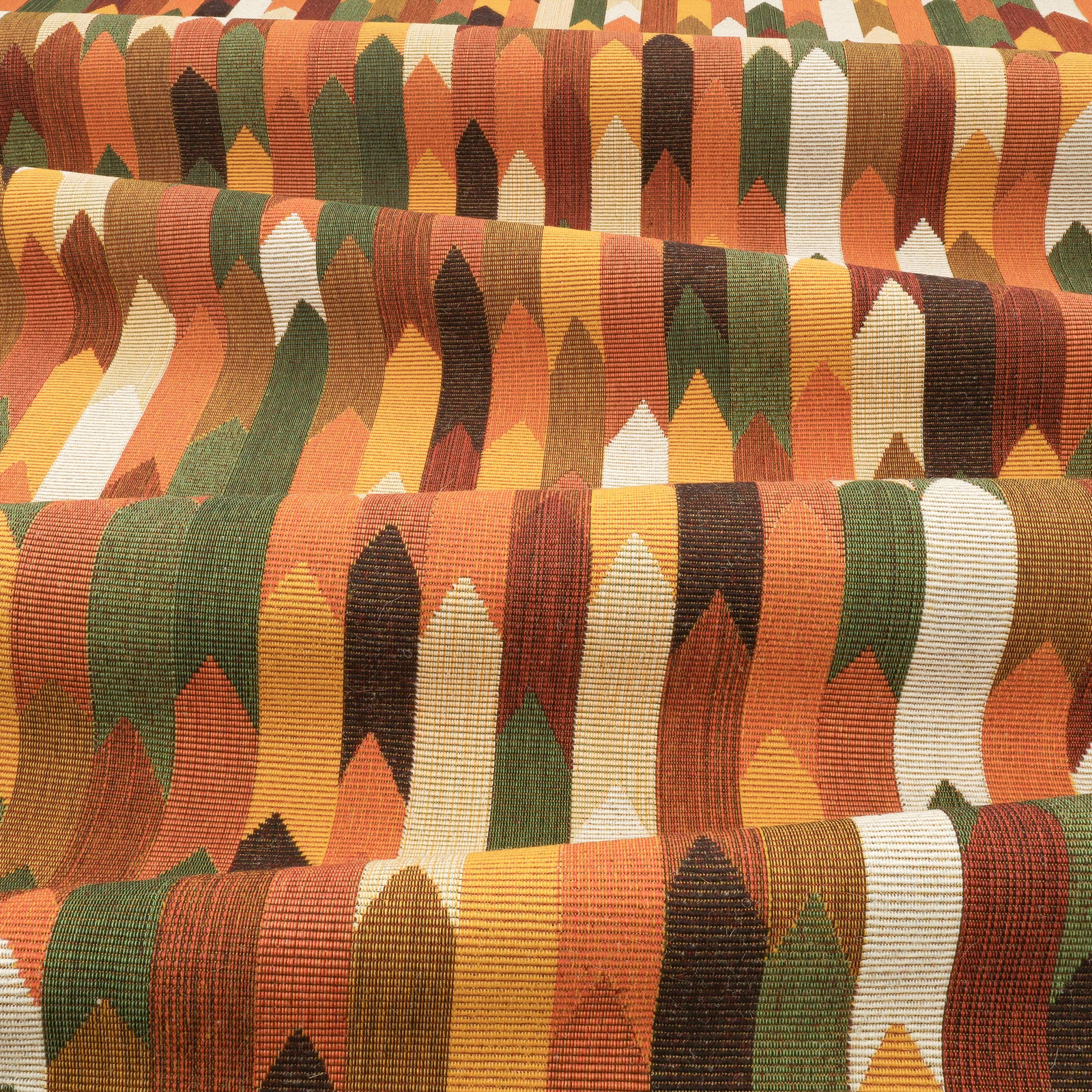 Rust, ochre, olive and cream ribbed geometric textile with repeating pointed forms