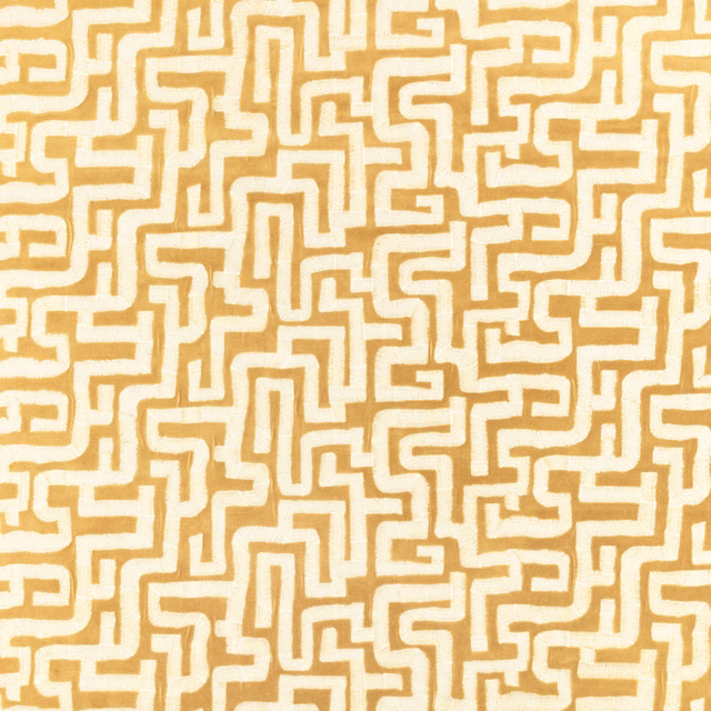 Warm ochre textile with cream maze lines in a dense geometric repeat