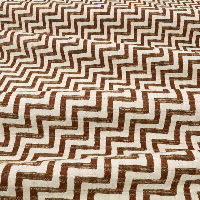 Warm teak-brown stepped lines on a textured ivory woven fabric