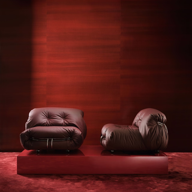 Deep oxblood red upholstery with subtle horizontal sheen on rounded lounge chairs