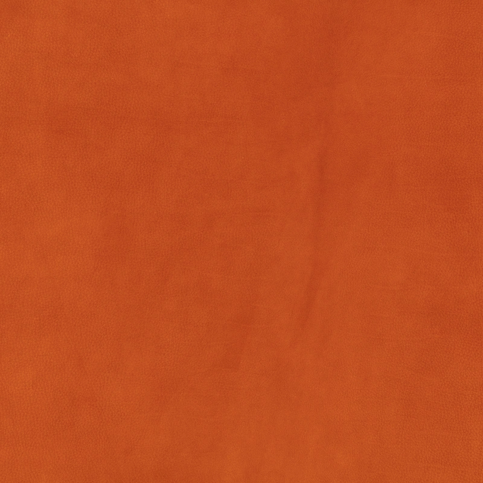 Close-up of plain burnt terracotta fabric with a soft, subtly mottled brushed texture