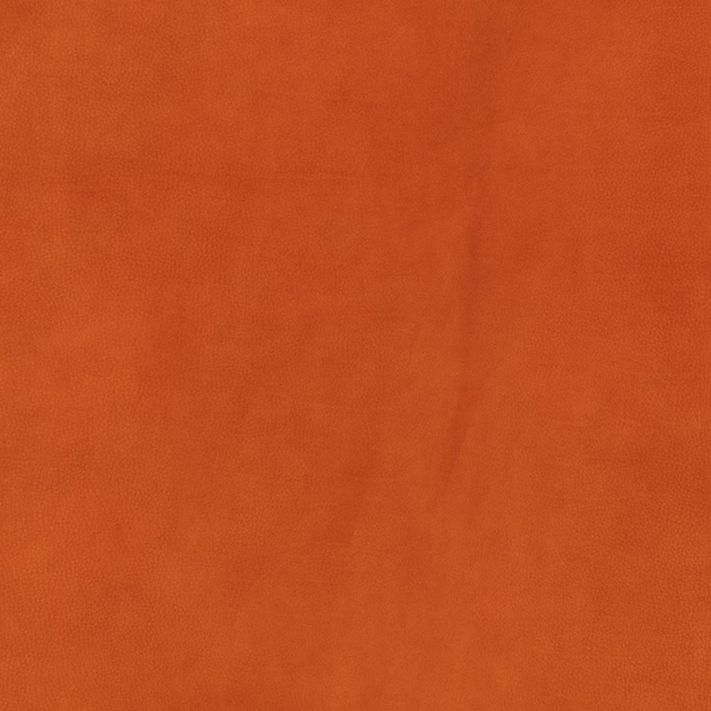 Close-up of plain burnt terracotta fabric with a soft, subtly mottled brushed texture