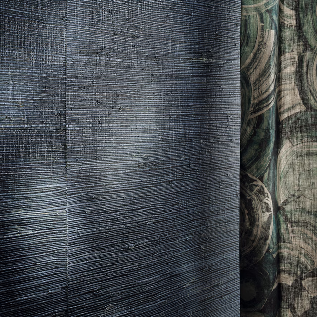 Deep blue-grey wallpaper with fine horizontal striations and shadowed organic arcs