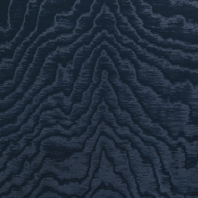 Deep navy-charcoal textile with slate woodgrain lines across a softly ribbed surface