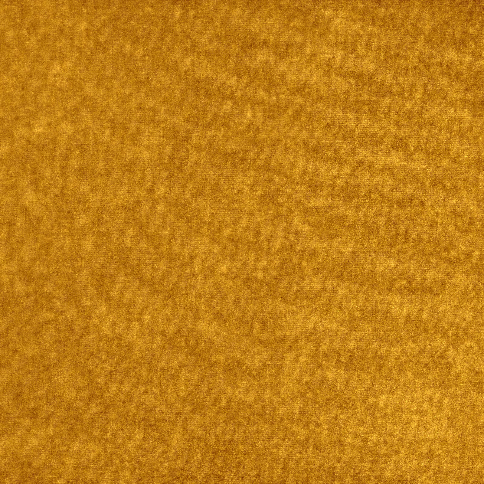 Close-up of warm ochre-gold textile with softly mottled, plush-looking surface