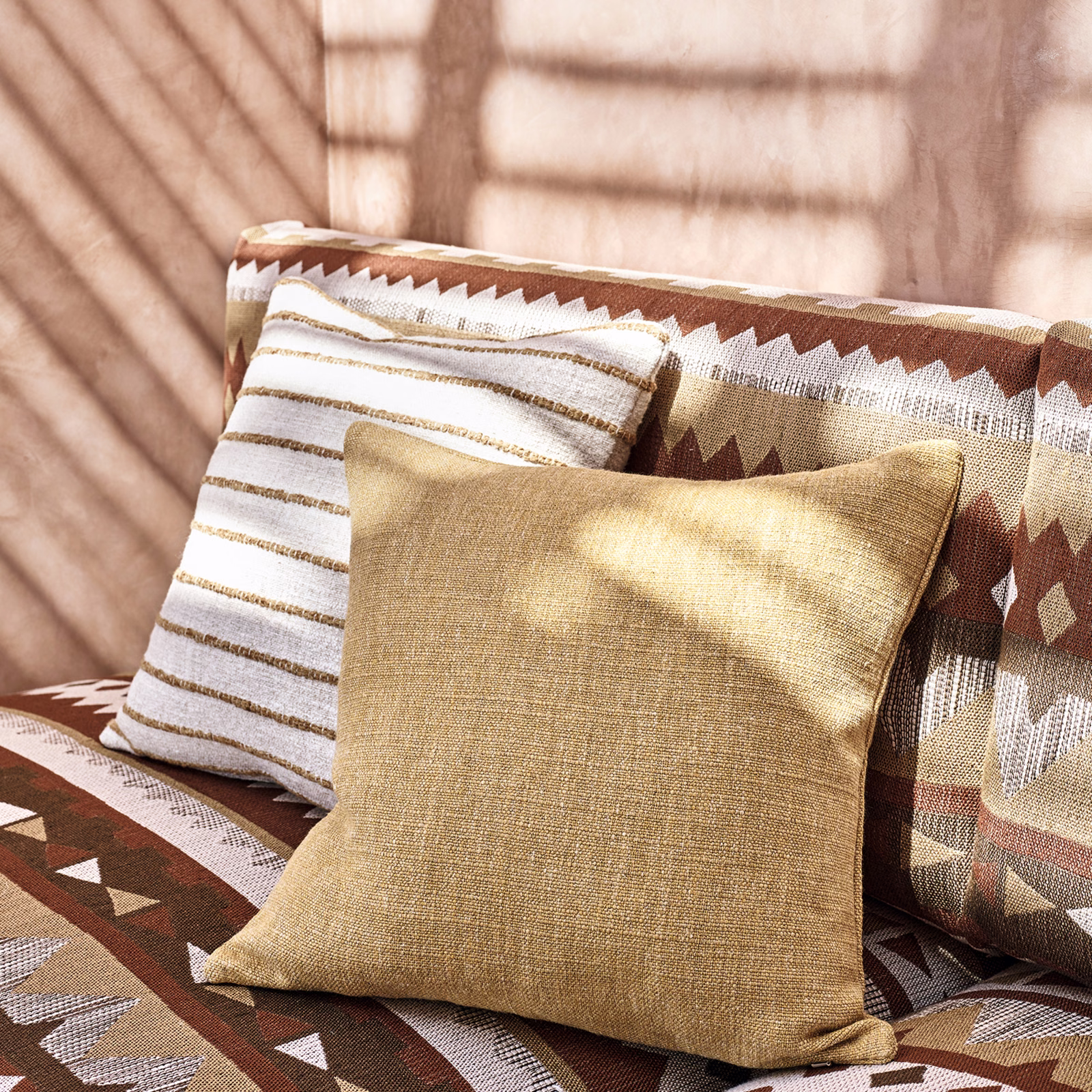 Warm ochre geometric woven upholstery with cream and brown stepped zigzags