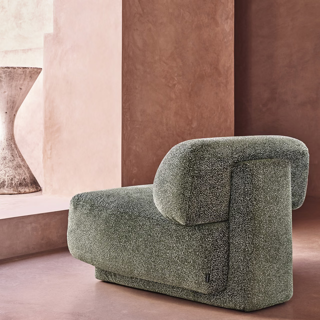 Muted cypress-green upholstery with fine peppered texture on a rounded chair