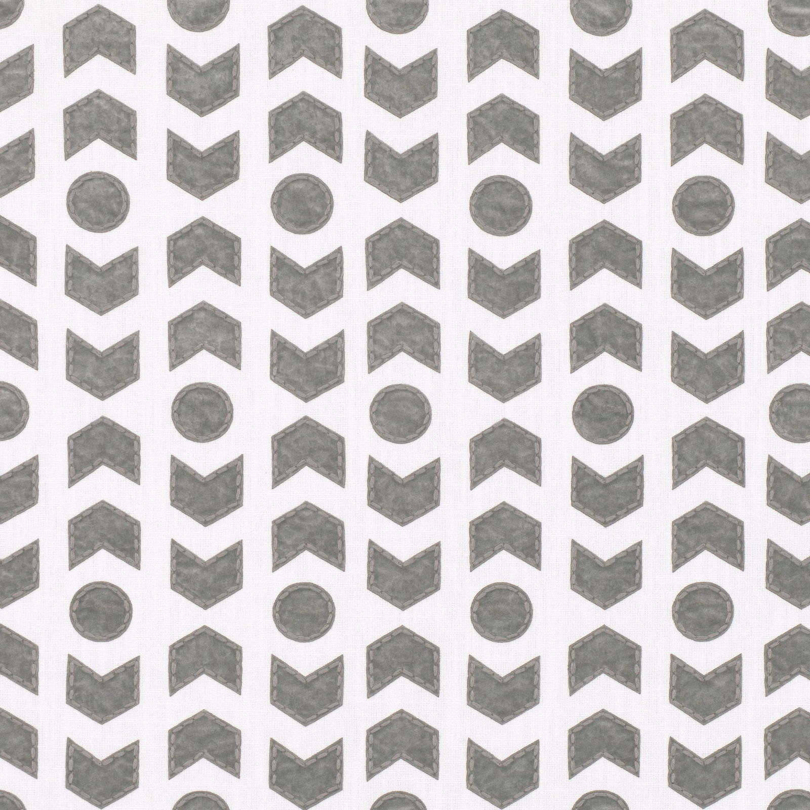 Pebble-grey arrowheads and circles repeating across an ivory textile ground