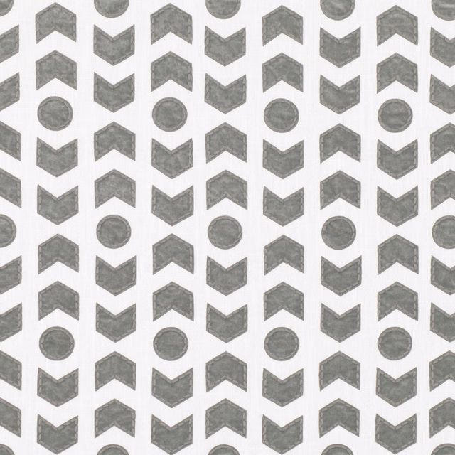 Pebble-grey arrowheads and circles repeating across an ivory textile ground