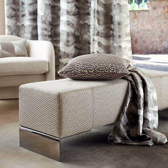 Warm taupe and charcoal marbled fabric hanging in soft, fluid curtain folds