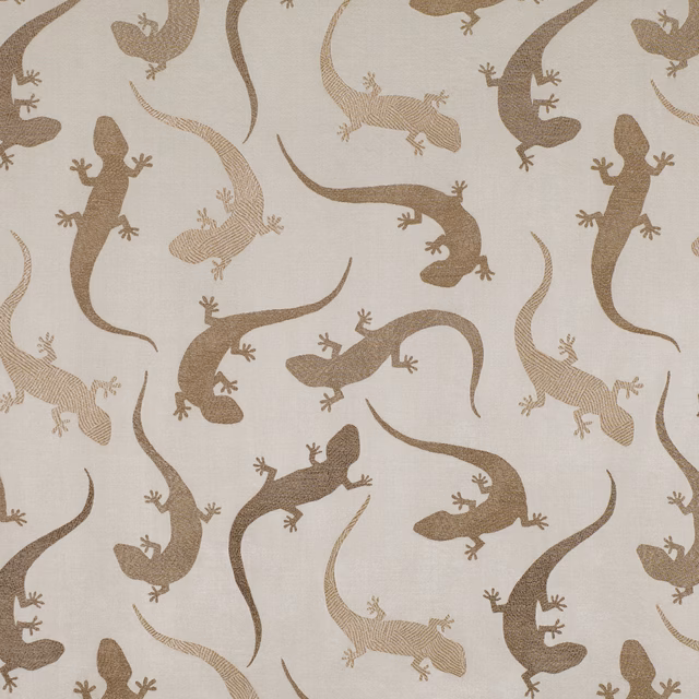 Cream textured fabric with scattered tobacco-brown salamanders and curling tails
