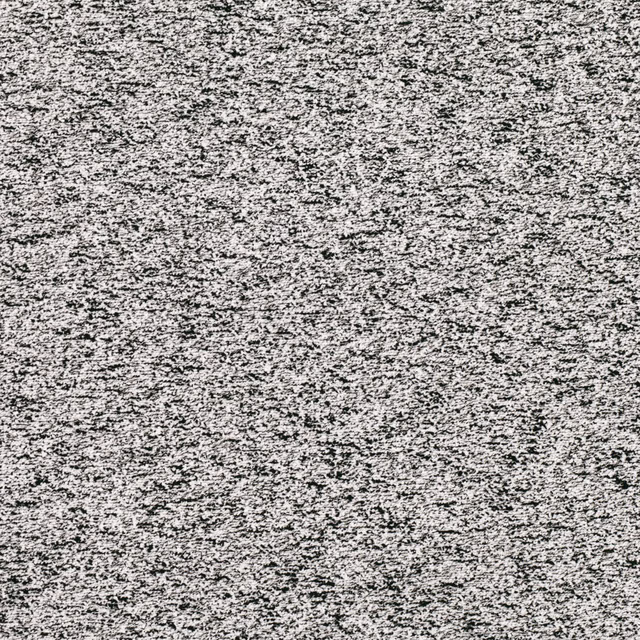 Cool grey-white woven textile with dense black flecks and broken horizontal texture