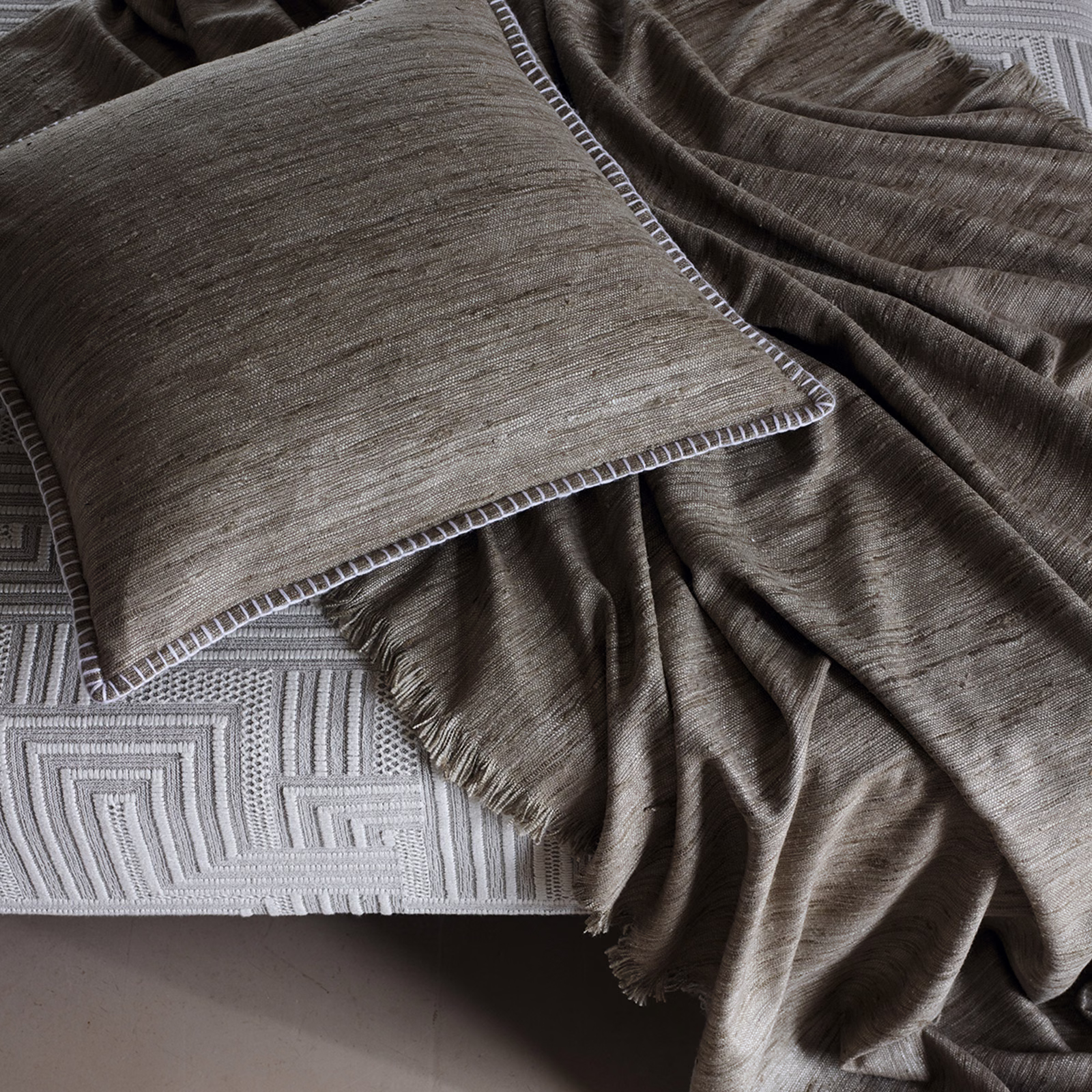 Taupe-brown Tanit Cobblestone textile with fine striations and softly lustrous folds