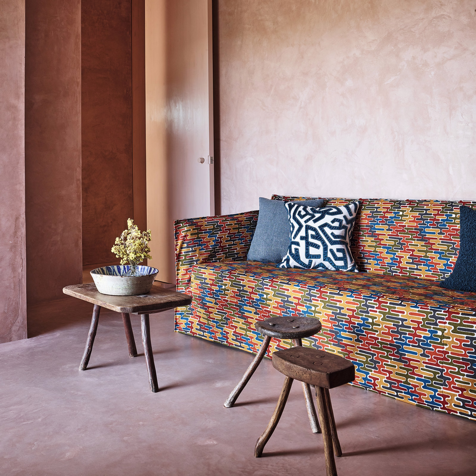Multicolour upholstery with navy, red, mustard and turquoise geometric brick motifs