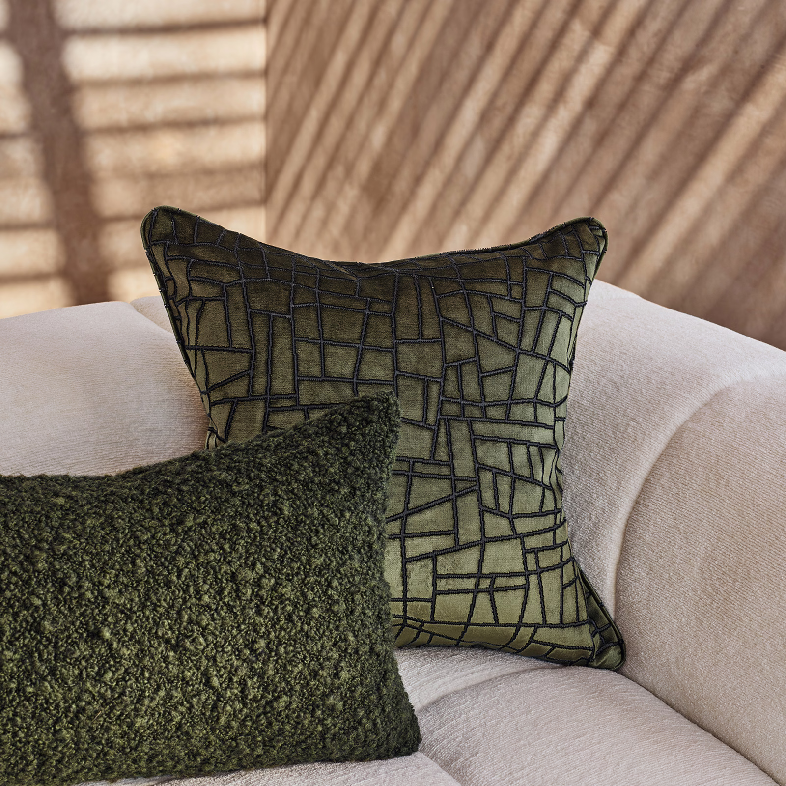 Olive cypress cushion fabric with a dark irregular geometric grid and softly nubby texture