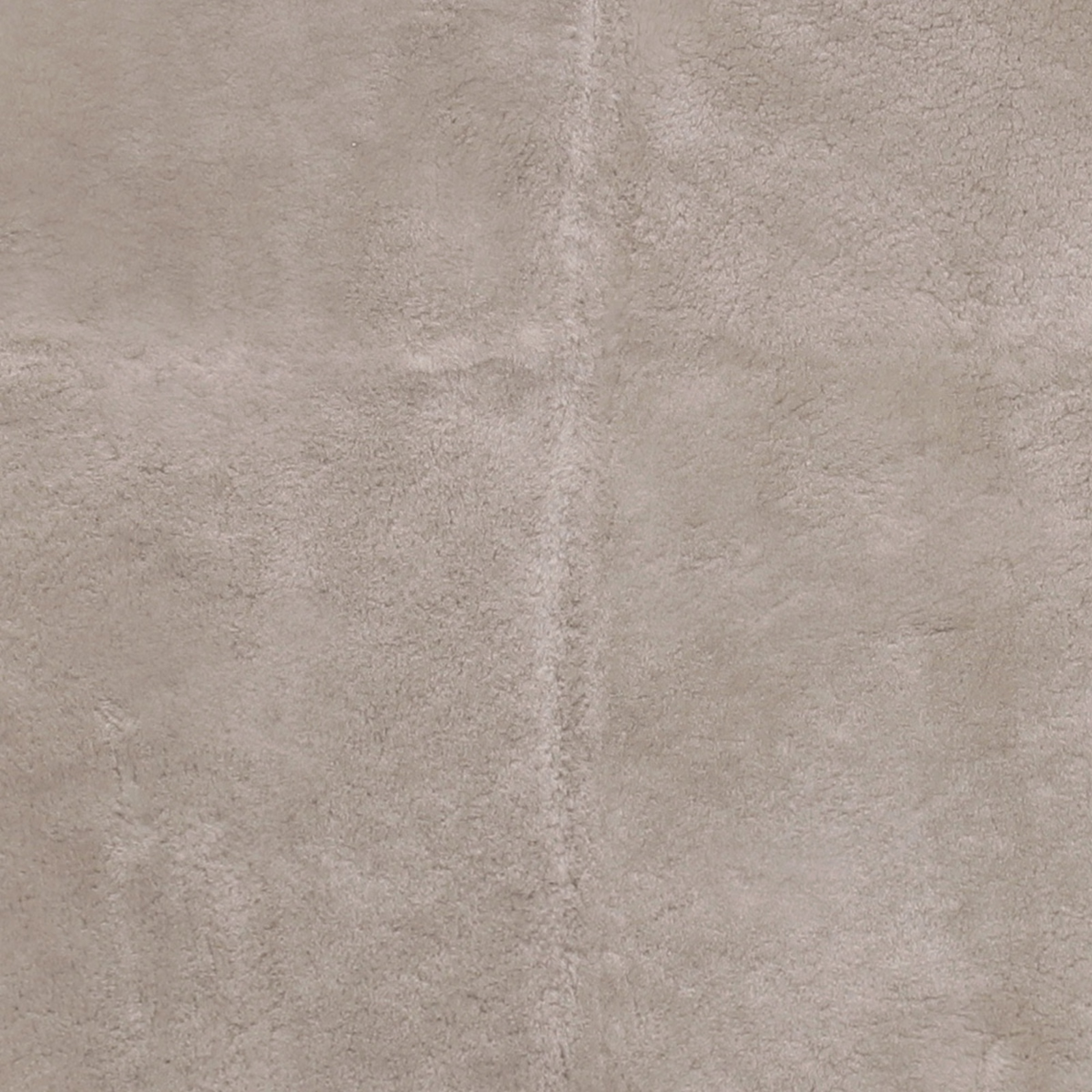 Warm buff-beige sheepskin-textured fabric with a softly mottled short pile
