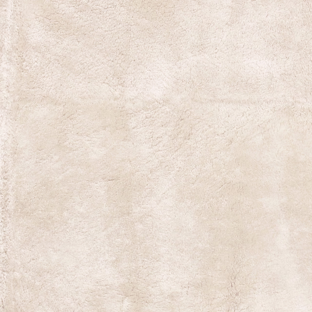 Pale ivory cream fabric with cloudy sheepskin-like texture and faint beige mottling