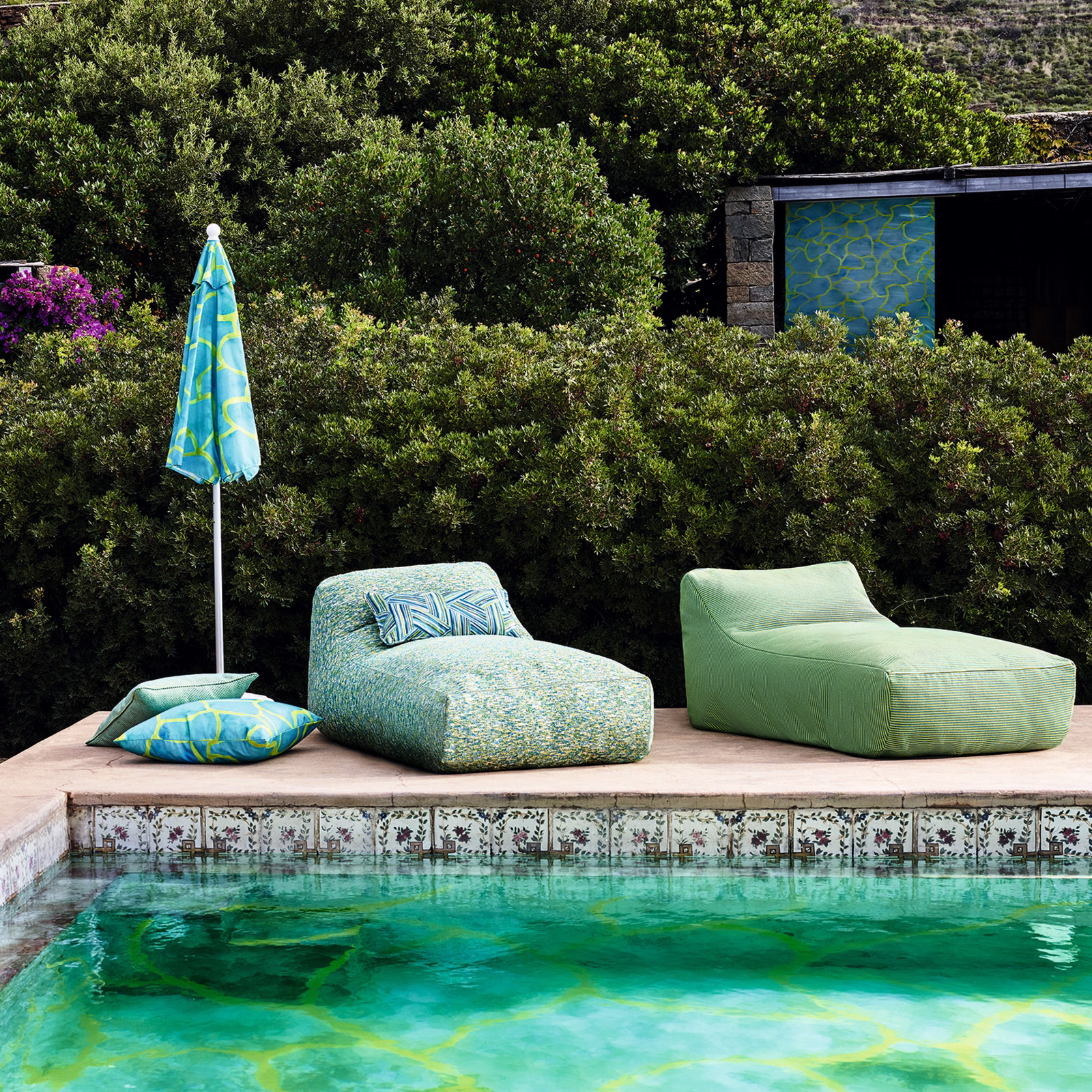 Aqua turquoise outdoor fabric with lime pool-like linework on outdoor poolside cushions