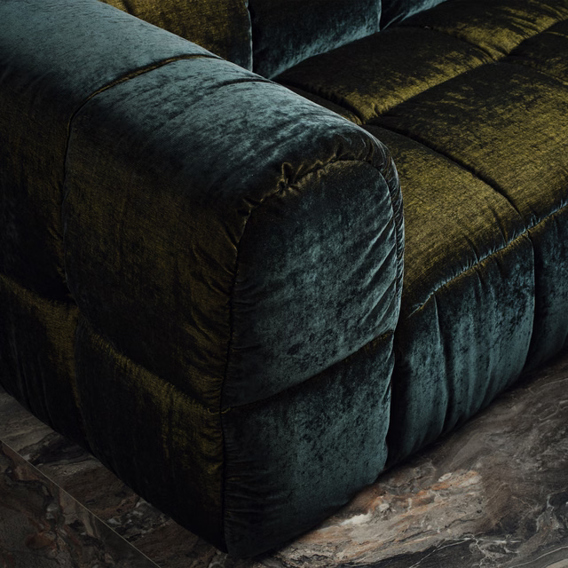 Deep ink-teal plush pile catching blue-green highlights on a curved upholstered sofa