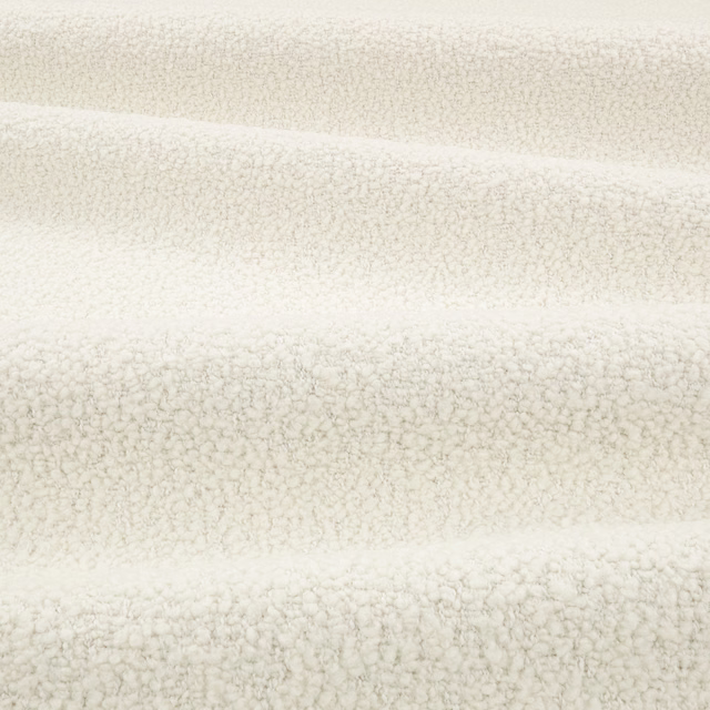 Warm bone bouclé fabric with dense irregular loops and soft horizontal folds