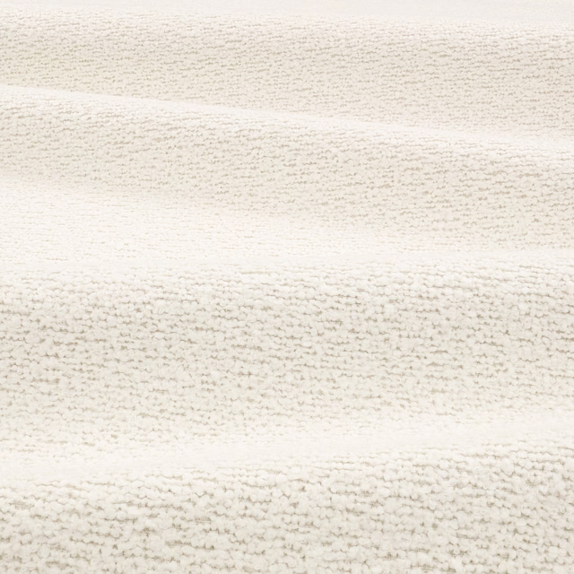 Chalk cream bouclé swatch showing irregular nubby rows and softly folded highlights