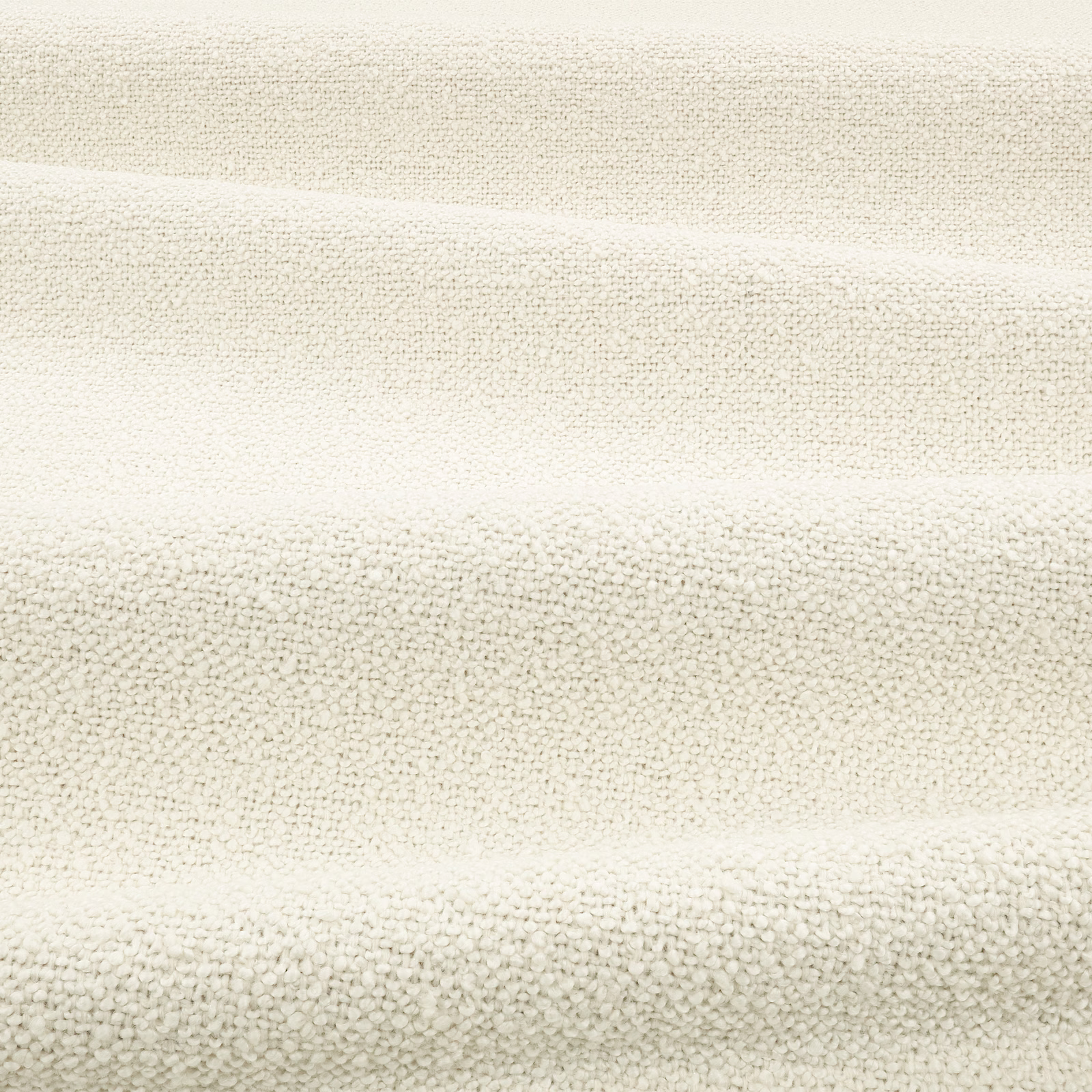 Warm bone bouclé with dense ivory loops and soft horizontal fold shadows