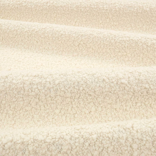 Warm vanilla ivory boucle with fine beige flecks and a softly looped pile
