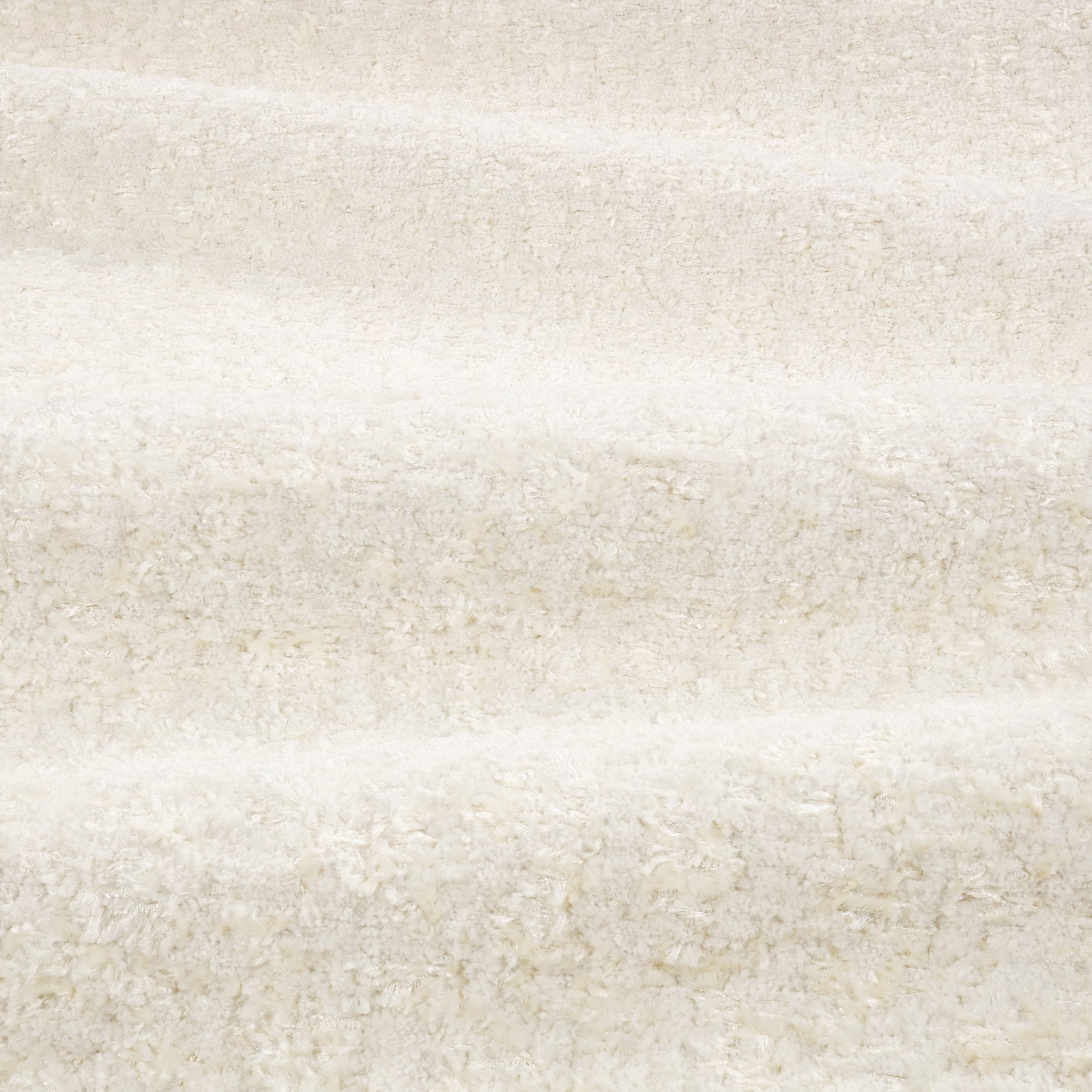 Ivory boucle fabric with pale beige mottling and shaggy horizontal texture