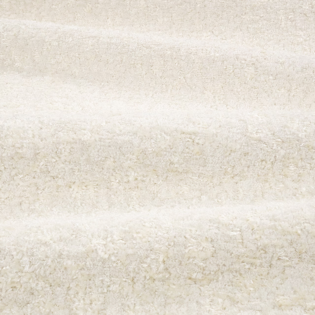 Ivory boucle fabric with pale beige mottling and shaggy horizontal texture
