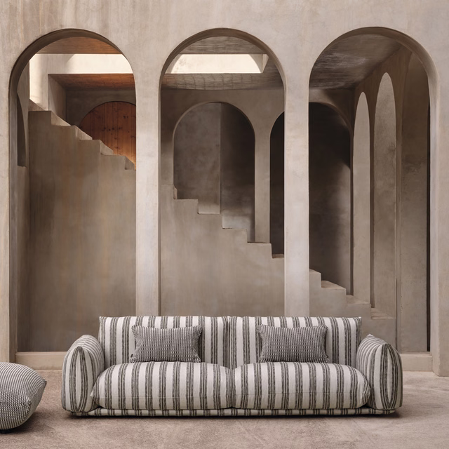 Warm taupe and charcoal vertical stripe upholstery on a rounded sofa