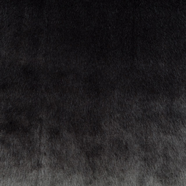 Charcoal-black plush fabric with smoky grey highlights and a directional brushed pile