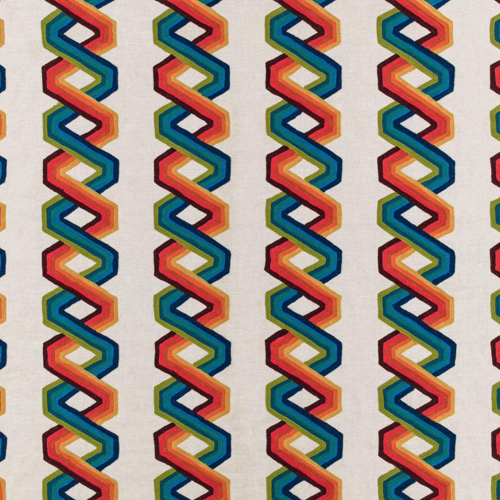 Cream textile with repeating multicoloured interlocking zigzag columns and fine woven texture