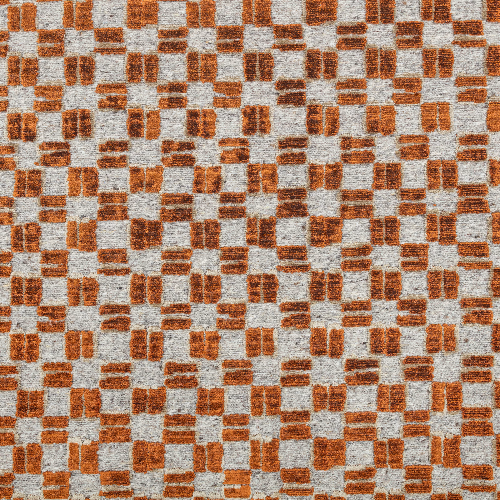 Warm cognac-brown woven blocks scattered across a pale grey textured ground