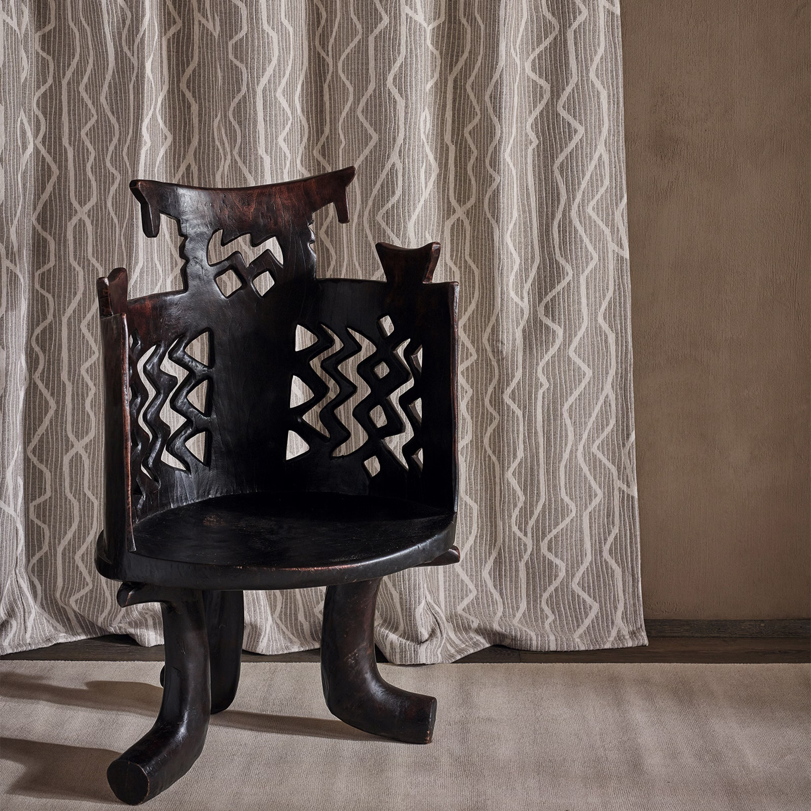 Warm taupe curtain with pale angular vertical lines and soft folds