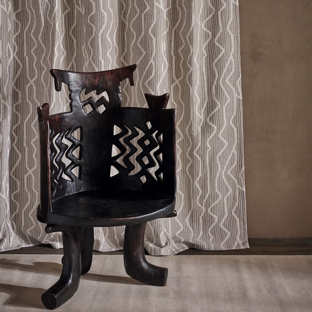 Warm taupe curtain with pale angular vertical lines and soft folds